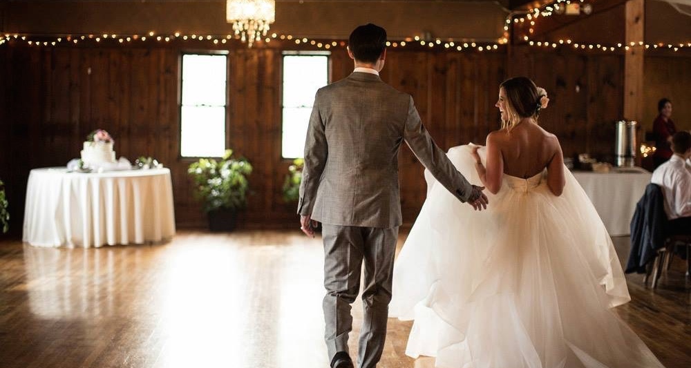 bride and groom walking into wedding venue