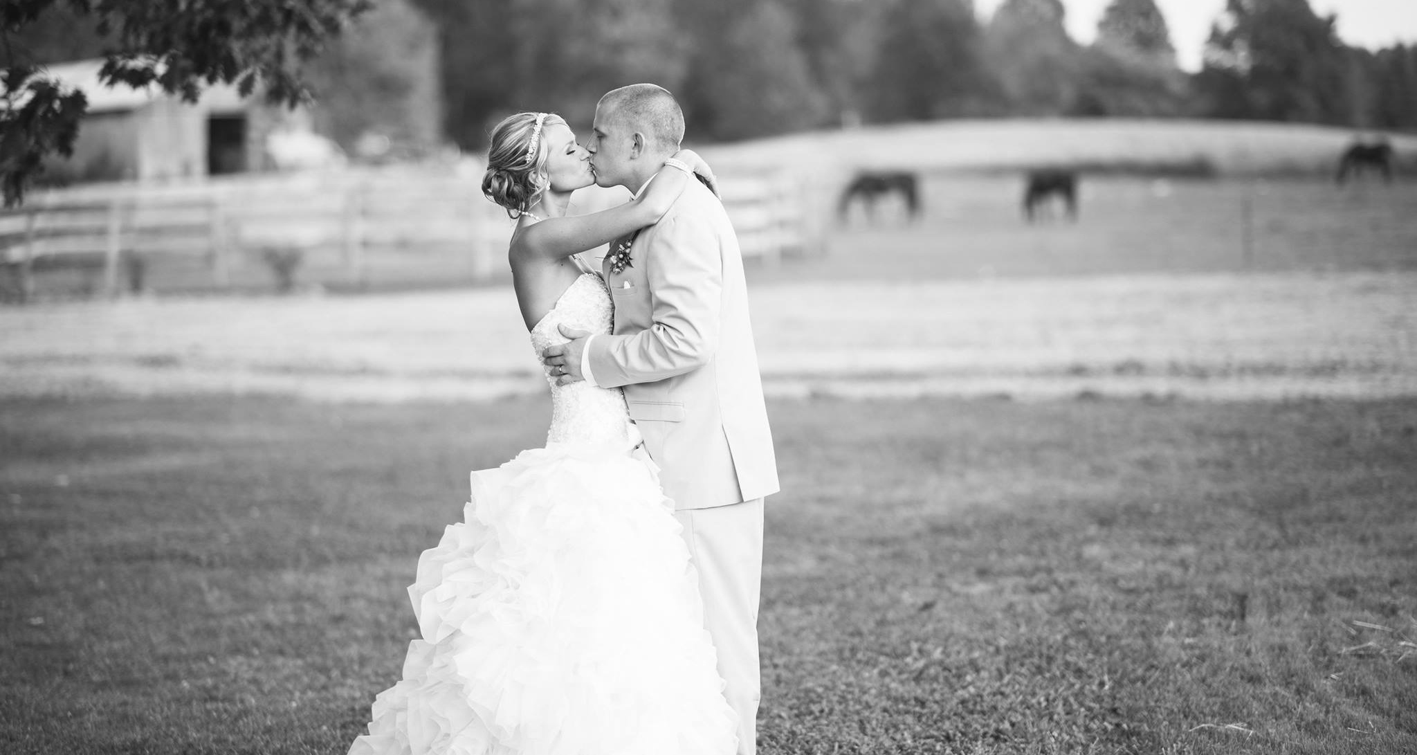 bride and groom kissing outside